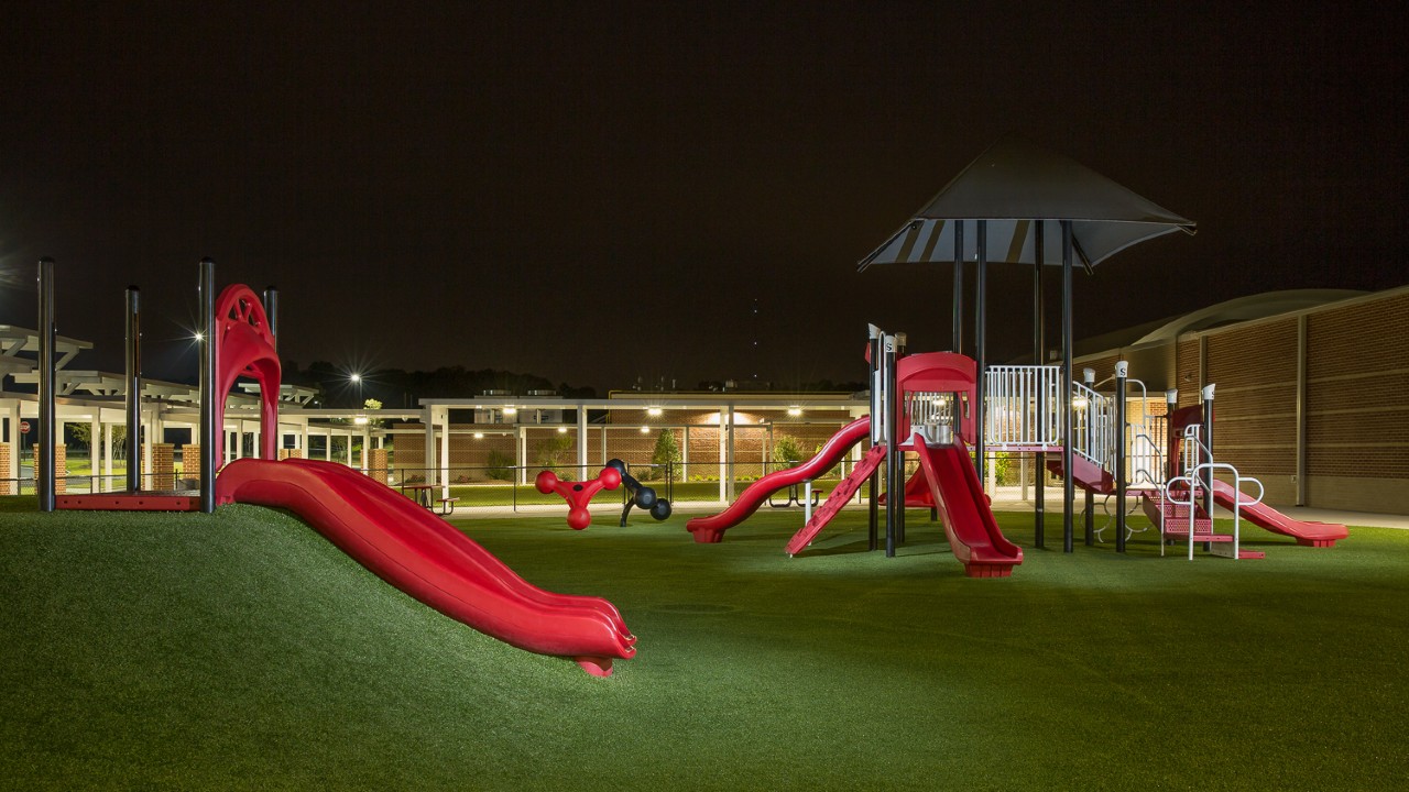 Nighttime artificial turf playground by Southwest Greens Charlotte